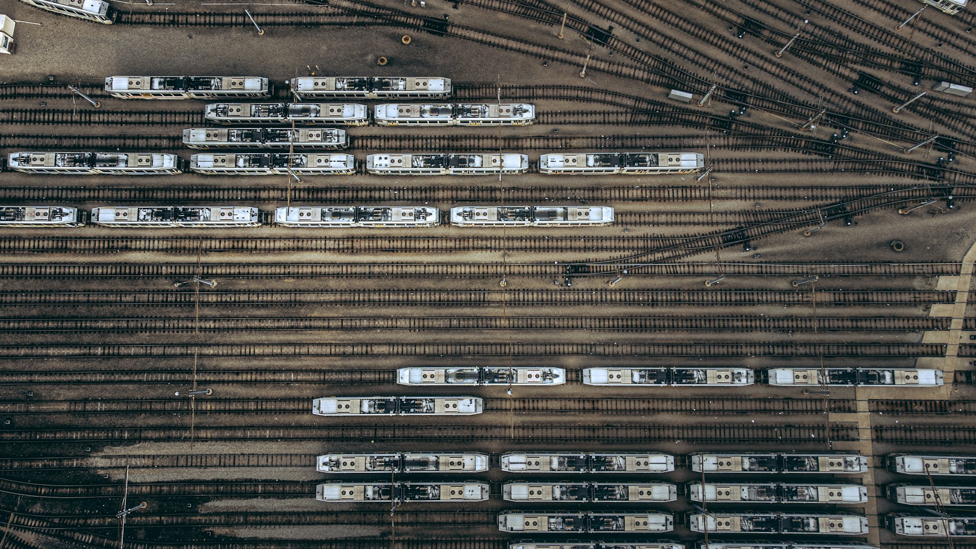 Overhead view of trains on parallel railway tracks, one per lane, illustrating Git worktrees isolation