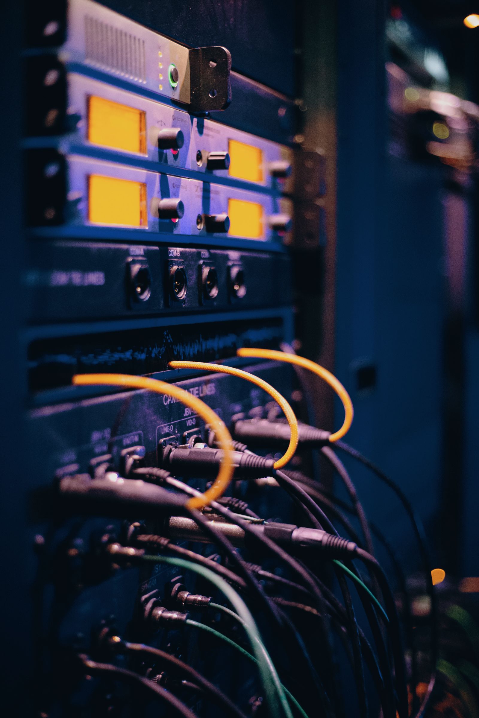Colored ethernet connectors plugged into a server rack, representing API connector access control