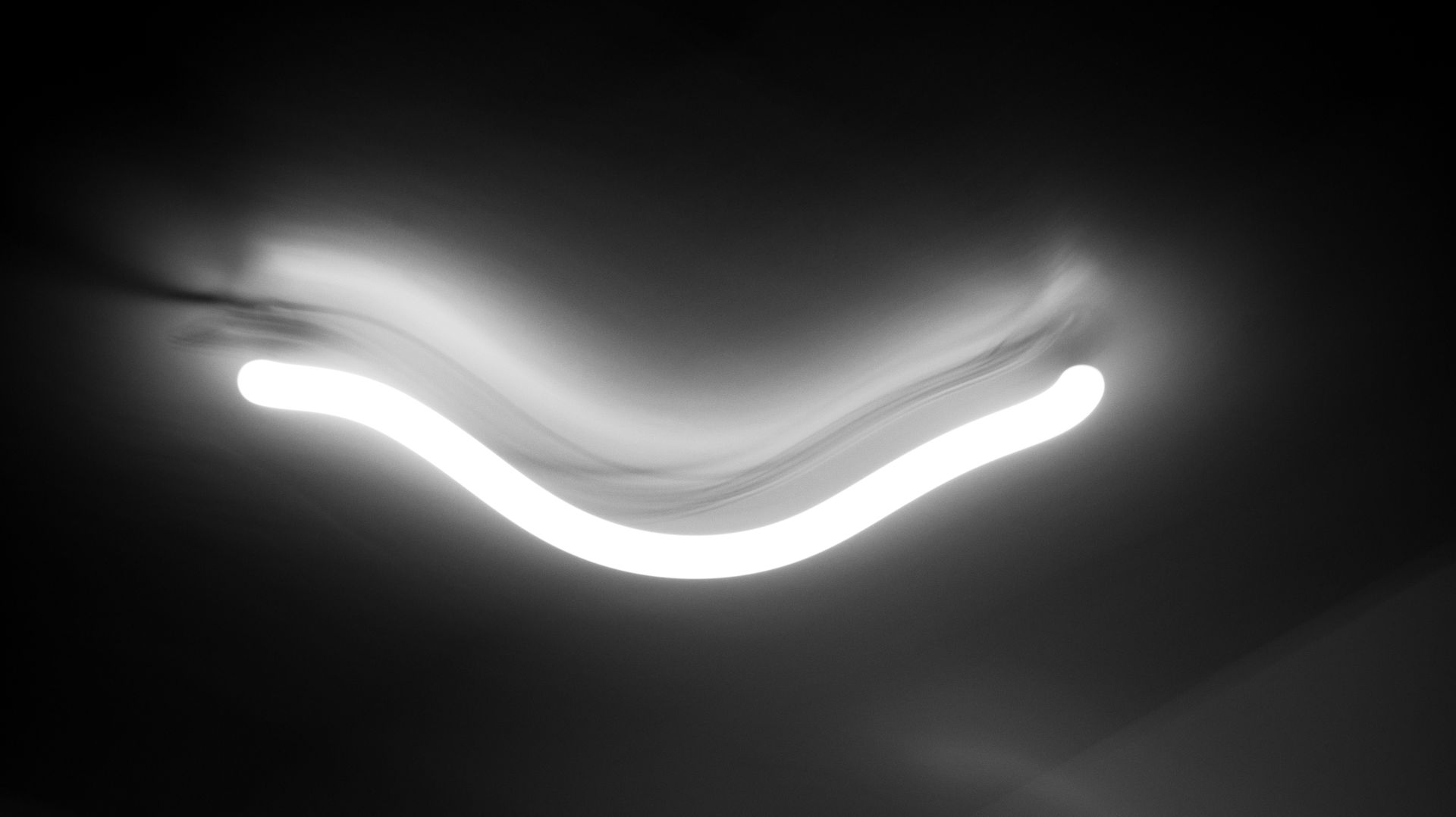 Smooth curved light trail in darkness representing stable streaming content interfaces