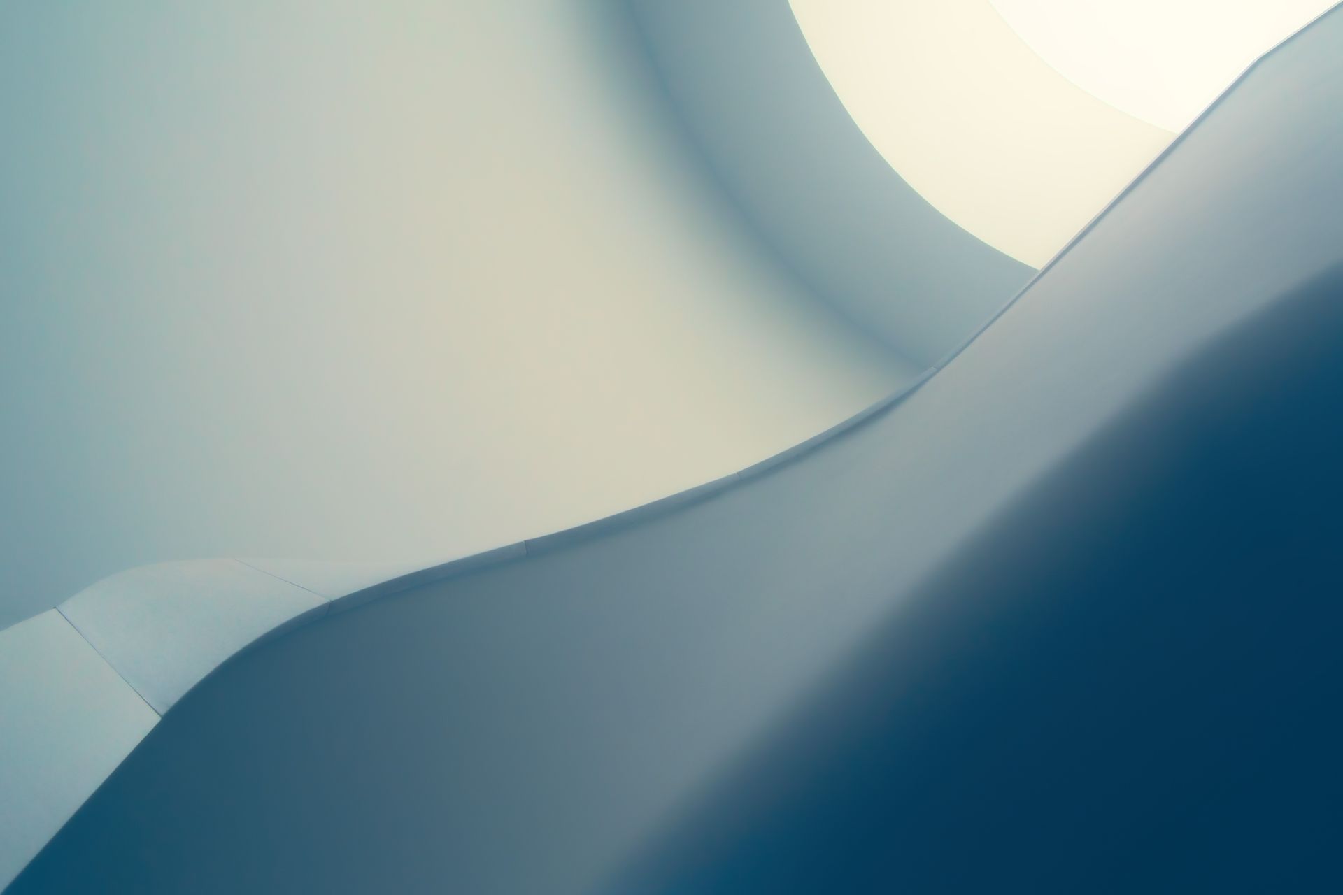 Minimal architectural ridge dividing light and shadow, evoking a corner-shape crease
