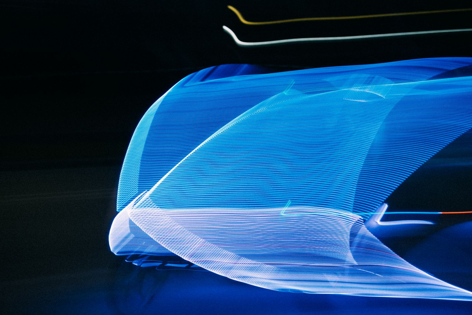 Flowing blue light trails merging into one smooth wave, symbolizing streaming data processing