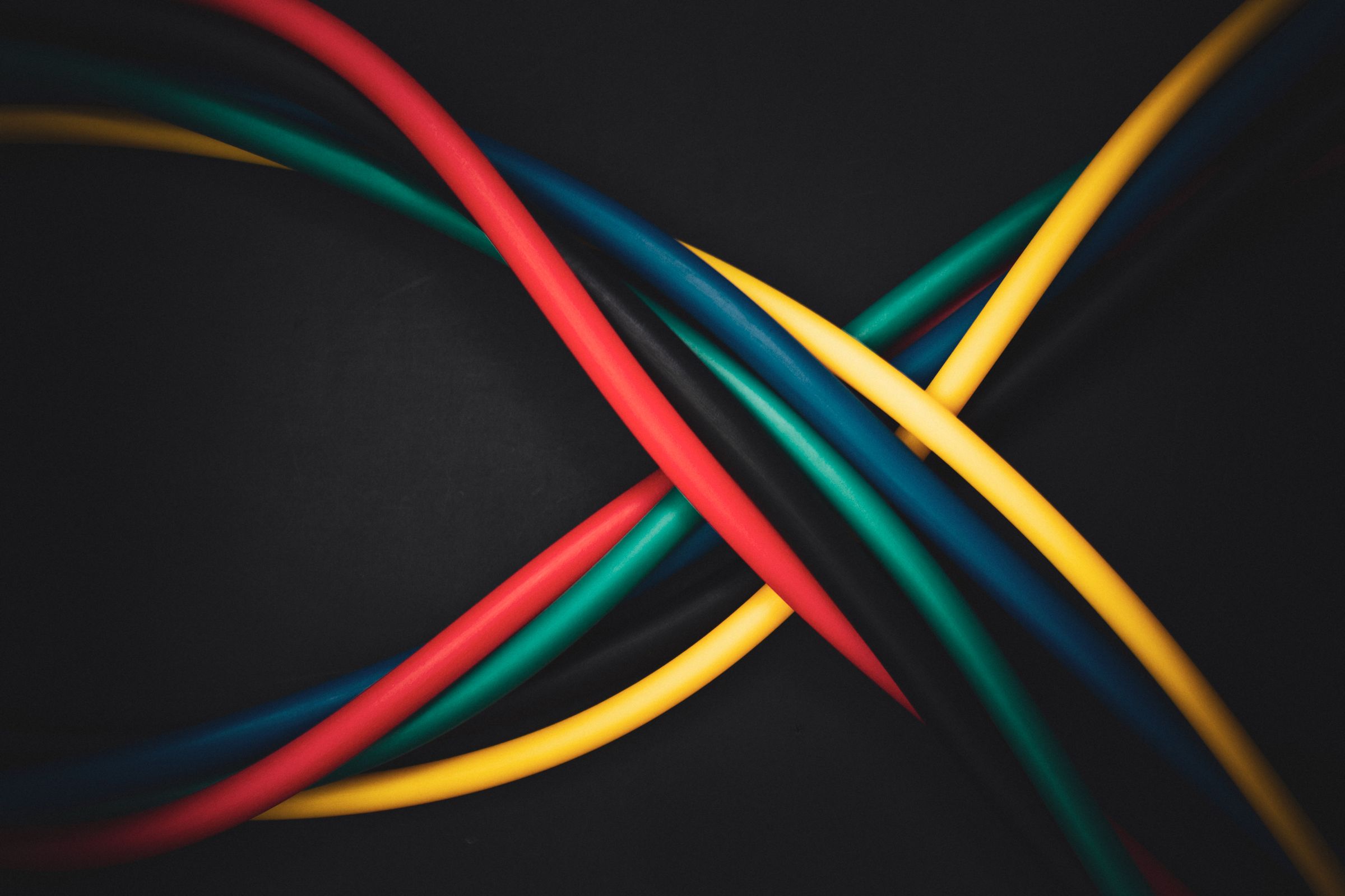 Five coloured cables crossing on black, the layered signals behind customer understanding
