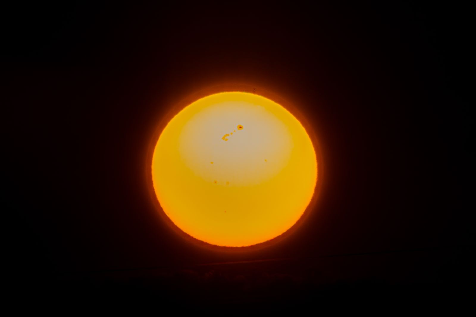 The sun's fiery disk with sunspots, illustrating rare event forecasting extremes