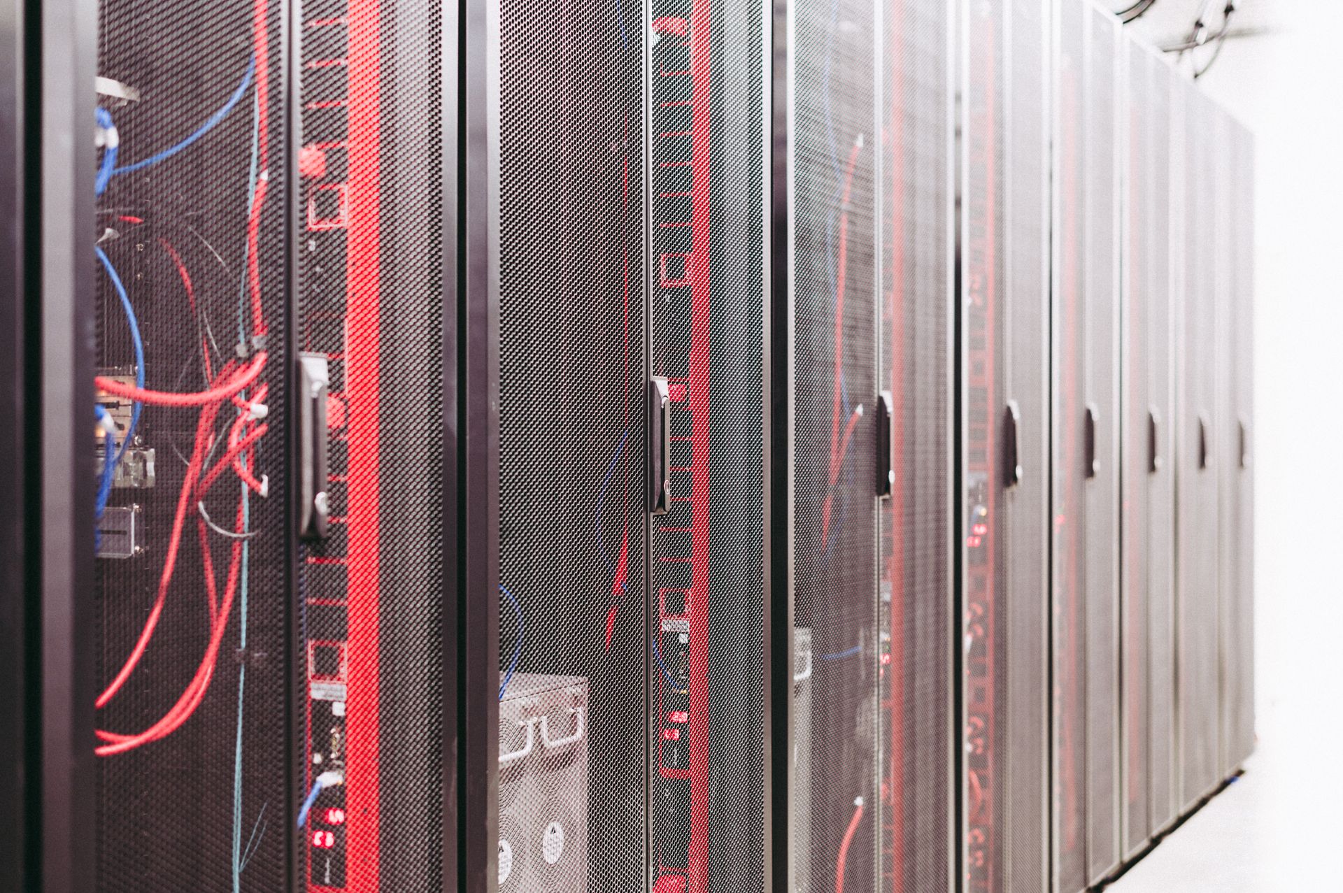 Row of server racks with cabling illustrating inference architecture infrastructure